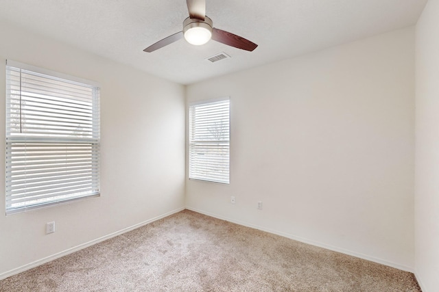 carpeted empty room featuring ceiling fan