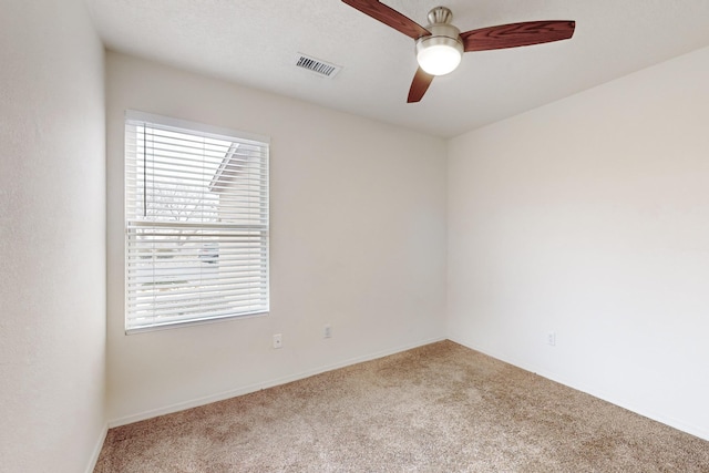 carpeted empty room featuring ceiling fan