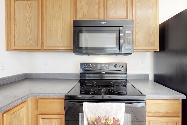 kitchen with light brown cabinetry and black range with electric stovetop