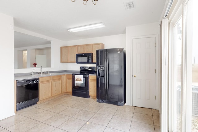 kitchen with black appliances, light tile patterned flooring, light brown cabinetry, and sink