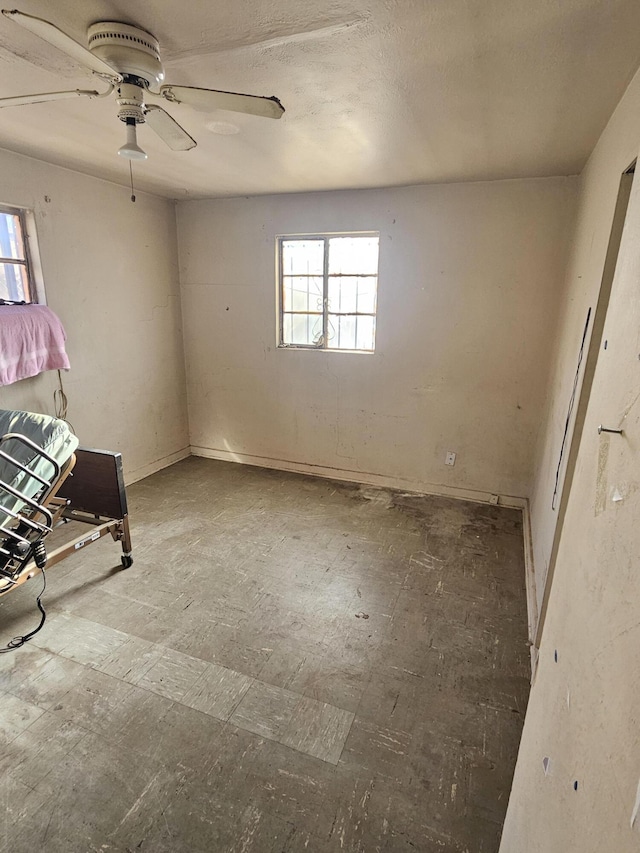 interior space with ceiling fan