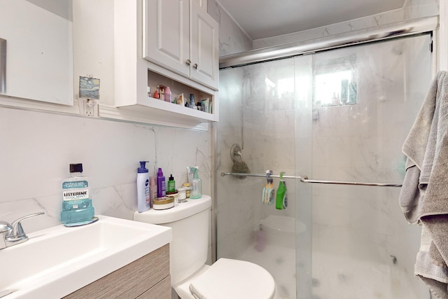 bathroom with toilet, vanity, decorative backsplash, and an enclosed shower