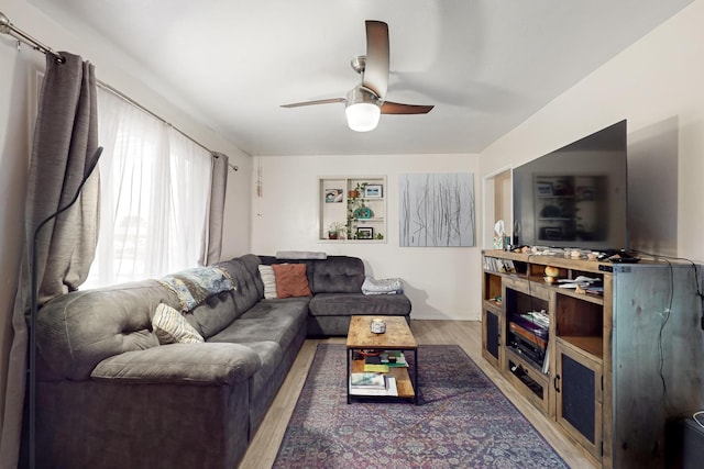 living room featuring hardwood / wood-style flooring and ceiling fan