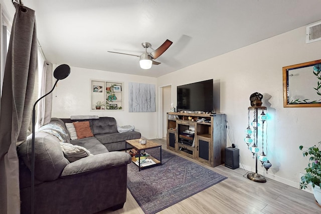 living room featuring ceiling fan and light hardwood / wood-style floors