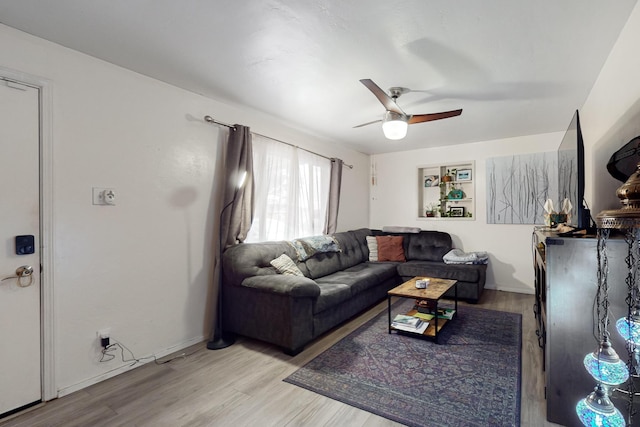 living room featuring ceiling fan and light hardwood / wood-style flooring