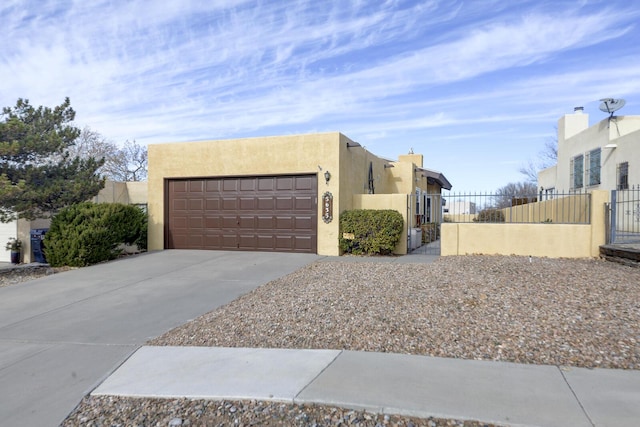 pueblo-style house featuring a garage