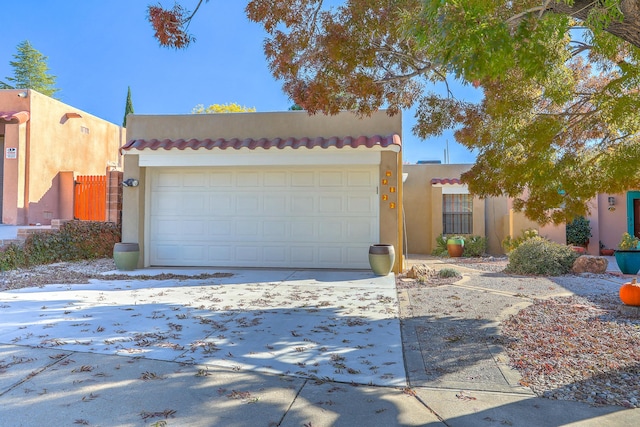 pueblo-style home with a garage