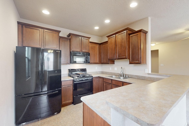 kitchen featuring ceiling fan, sink, kitchen peninsula, a textured ceiling, and black appliances