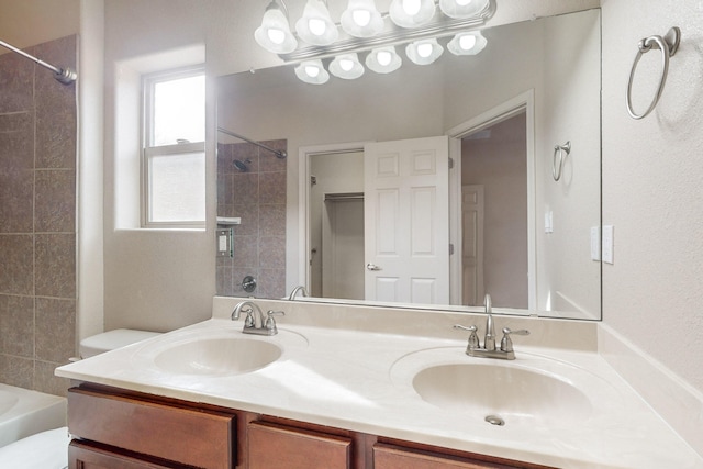 full bathroom with vanity, toilet, and tiled shower / bath