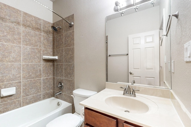 full bathroom featuring vanity, toilet, and tiled shower / bath