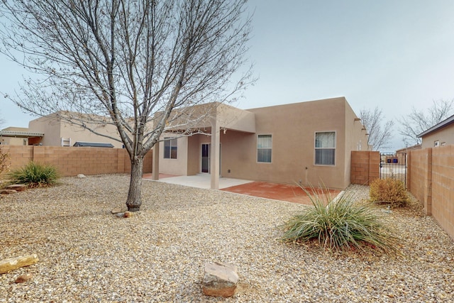 rear view of property featuring a patio