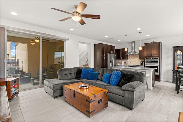 living room with ceiling fan and light tile patterned flooring