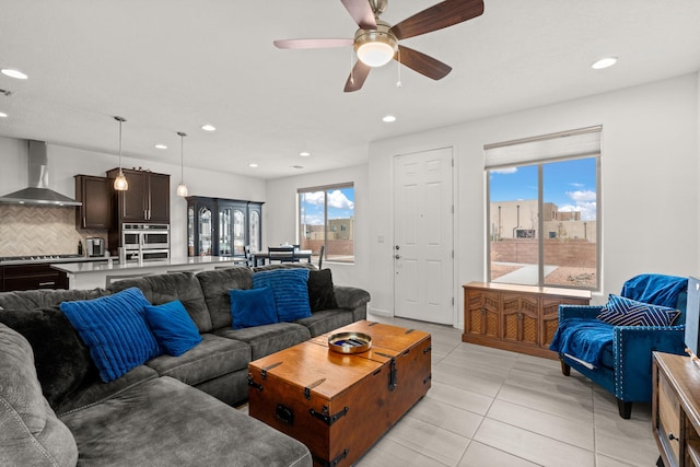 tiled living room featuring ceiling fan