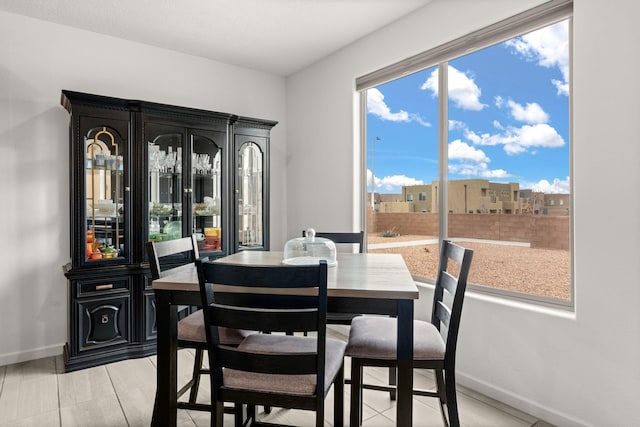 dining space featuring light tile patterned flooring