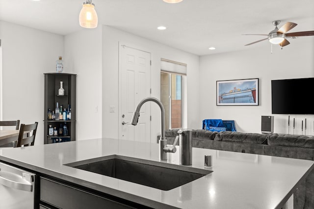 kitchen featuring pendant lighting, dishwasher, ceiling fan, and sink