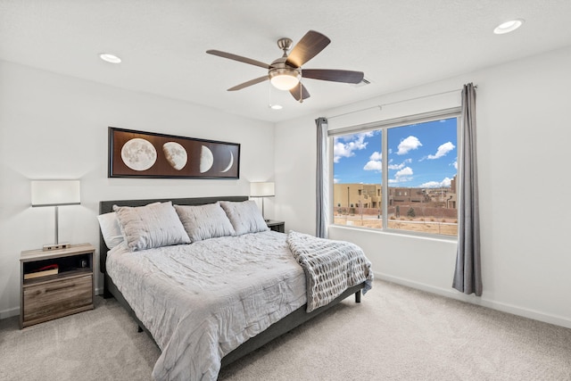 bedroom featuring ceiling fan and light colored carpet