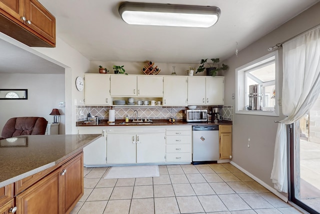 kitchen featuring backsplash, stainless steel appliances, white cabinets, and sink