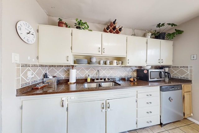 kitchen featuring stainless steel appliances, white cabinetry, decorative backsplash, and sink