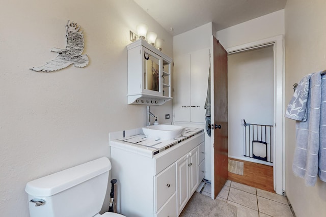 bathroom with vanity, tile patterned flooring, and toilet