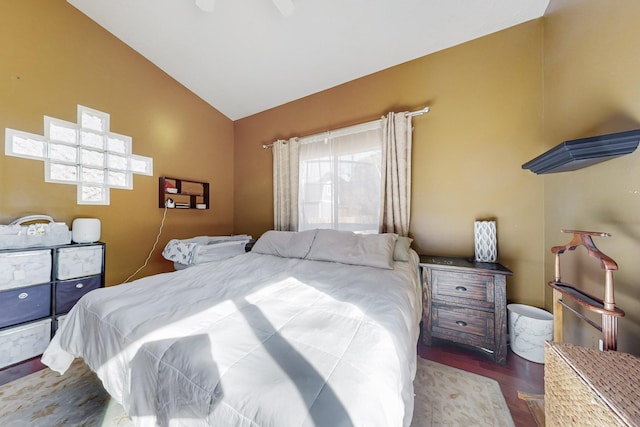 bedroom featuring vaulted ceiling, dark wood-type flooring, and ceiling fan