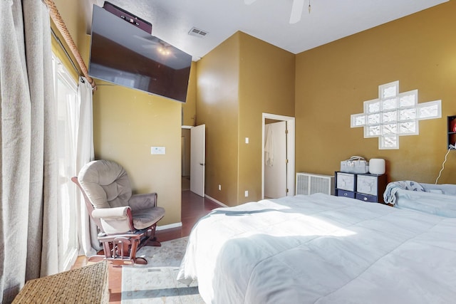 bedroom with a towering ceiling and ceiling fan