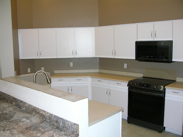 kitchen featuring black electric range oven, white cabinetry, sink, and light tile patterned floors