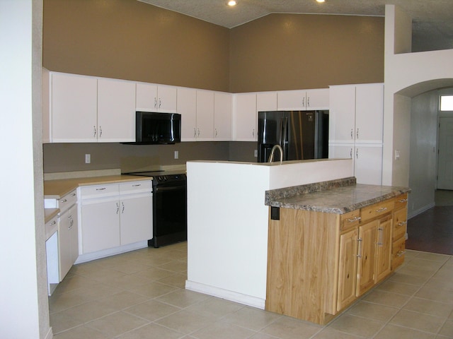 kitchen featuring white cabinetry, a center island with sink, high vaulted ceiling, and black appliances