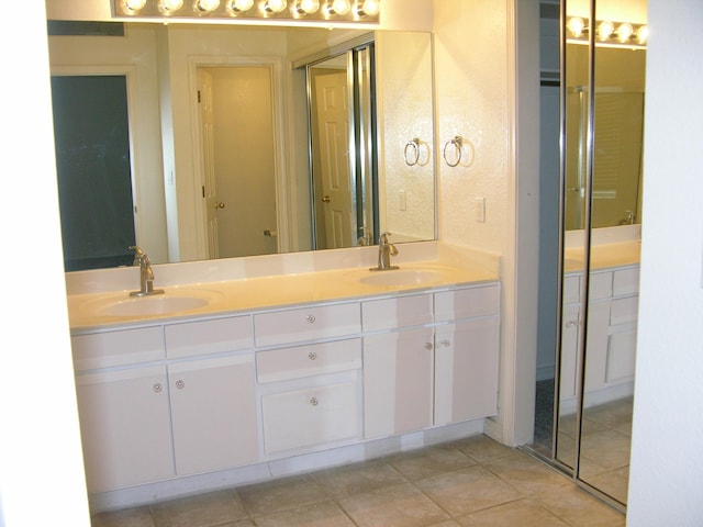 bathroom with tile patterned flooring and vanity