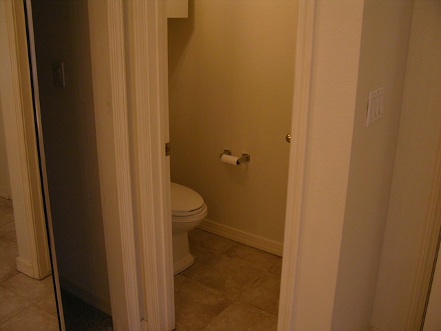 bathroom featuring tile patterned flooring and toilet