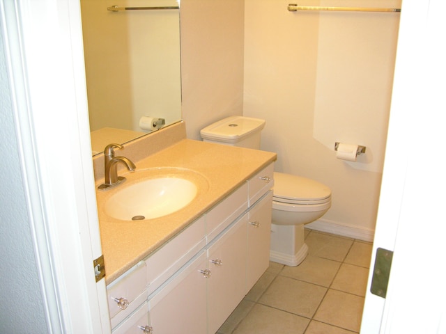 bathroom featuring toilet, vanity, and tile patterned floors