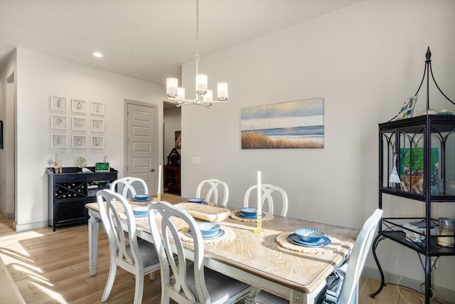 dining room featuring a notable chandelier and light wood-type flooring