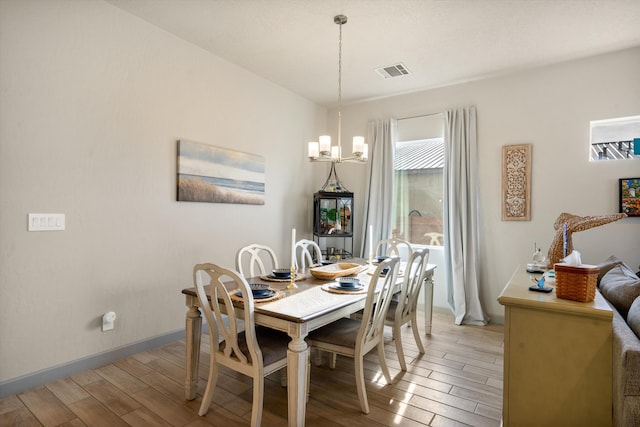 dining space featuring a chandelier