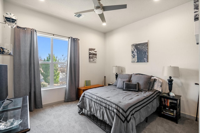 bedroom featuring ceiling fan and carpet