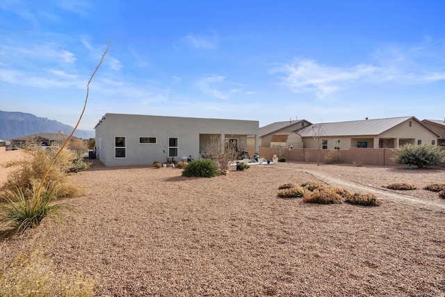 rear view of property featuring a mountain view