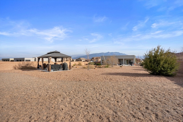 view of yard featuring a gazebo and a mountain view