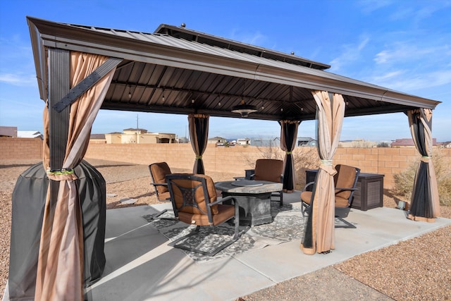 view of patio / terrace with a gazebo and a fire pit