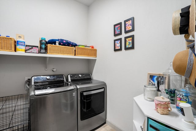 clothes washing area with independent washer and dryer and light tile patterned floors