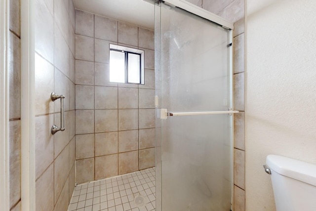 bathroom with toilet and walk in shower