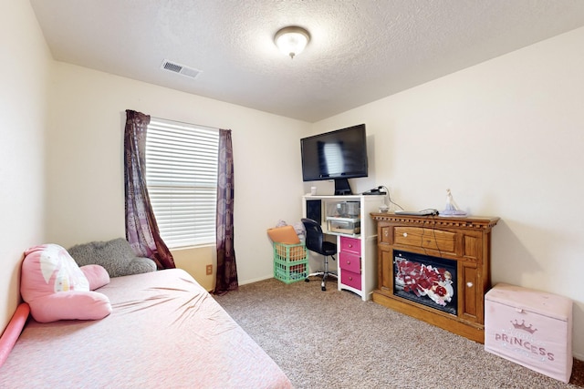 carpeted bedroom with a textured ceiling