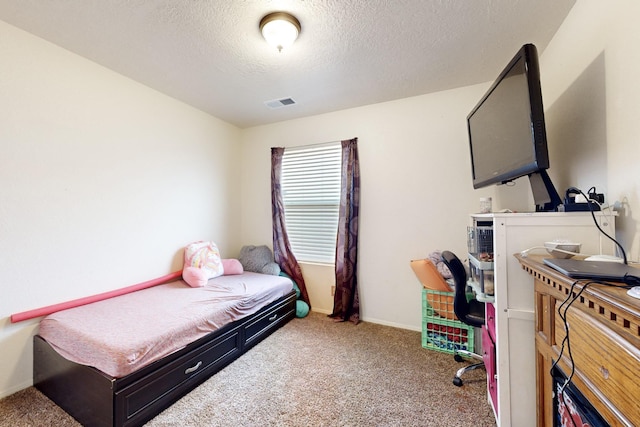 carpeted bedroom featuring a textured ceiling