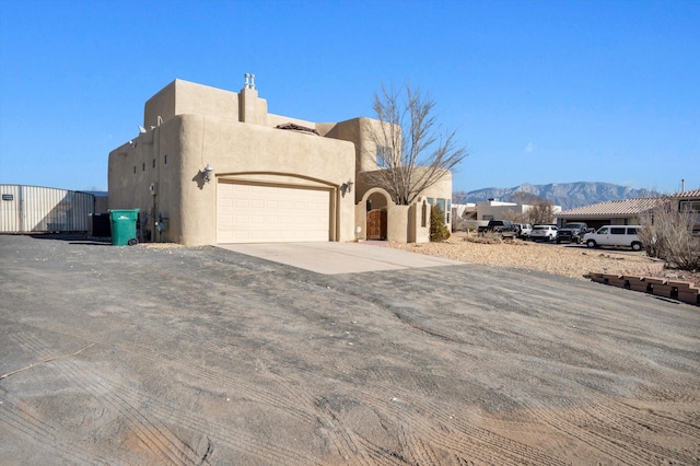 view of front of home featuring a garage and a mountain view