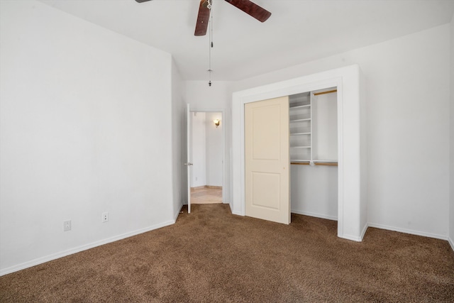 unfurnished bedroom with dark carpet, ceiling fan, and a closet