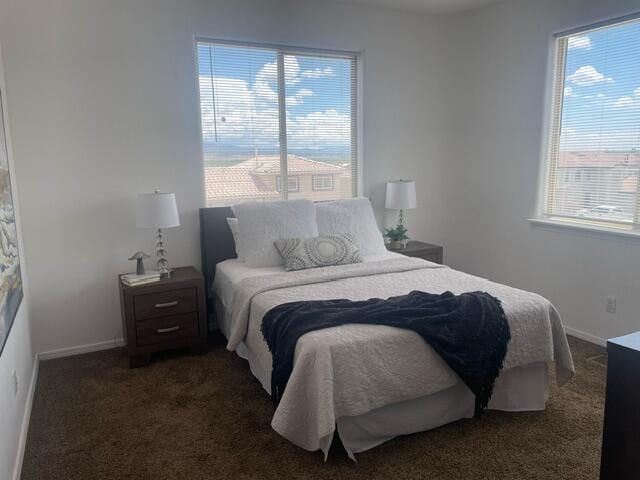 bedroom featuring carpet and baseboards