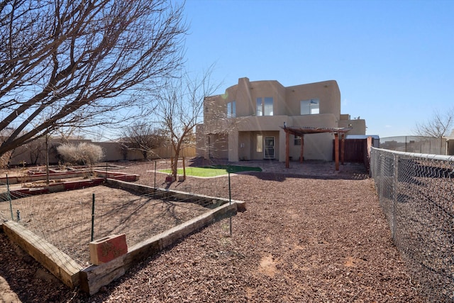 rear view of house featuring a pergola