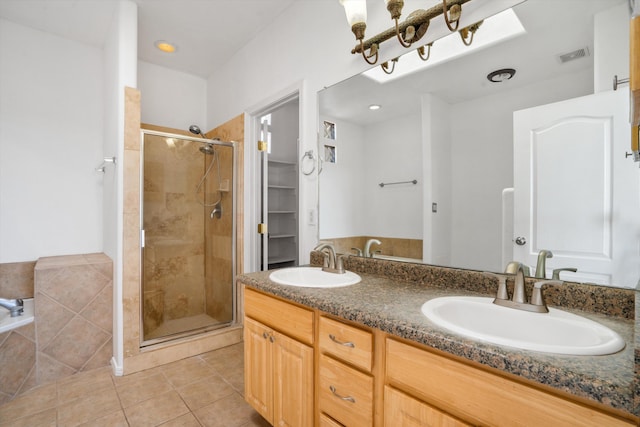 bathroom with vanity, tile patterned floors, and a shower with shower door