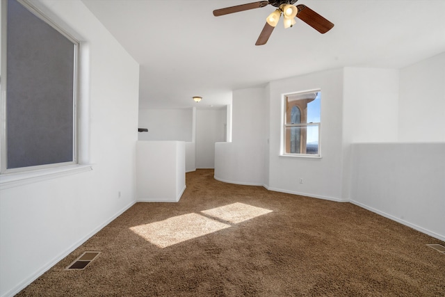 carpeted spare room with ceiling fan