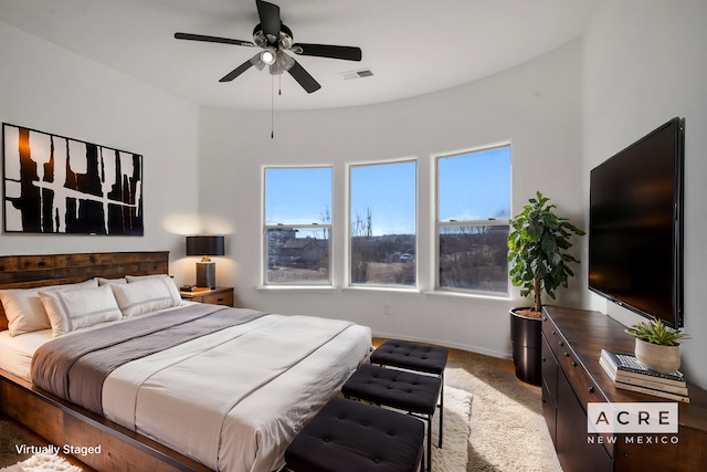 bedroom featuring ceiling fan and carpet