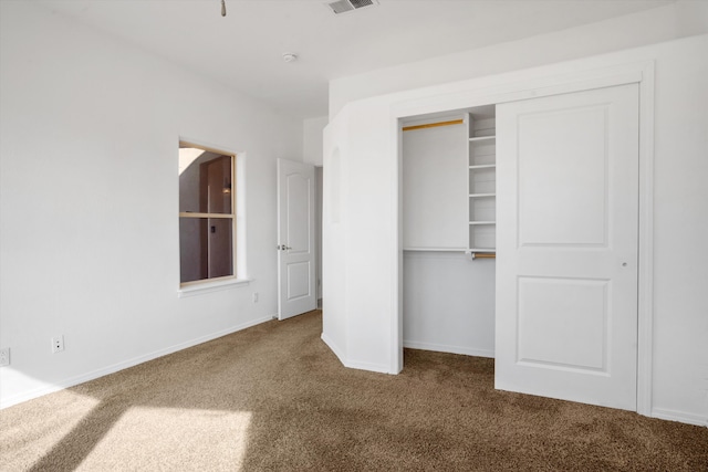 unfurnished bedroom with a closet and carpet flooring