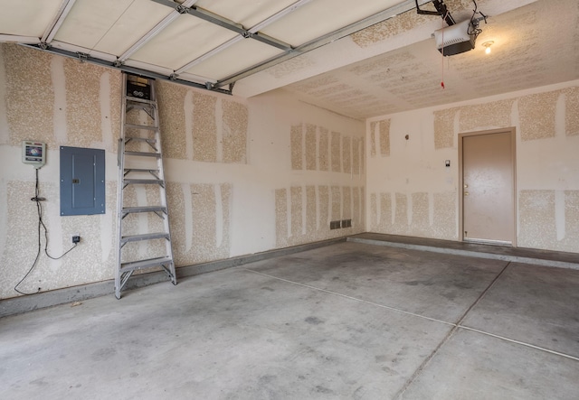 garage with electric panel and a garage door opener