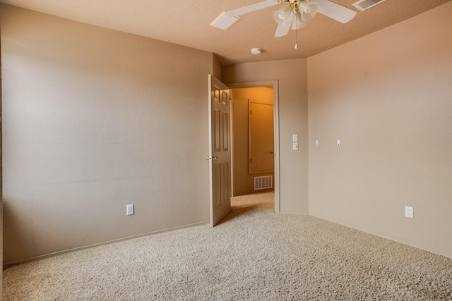 spare room featuring carpet and ceiling fan